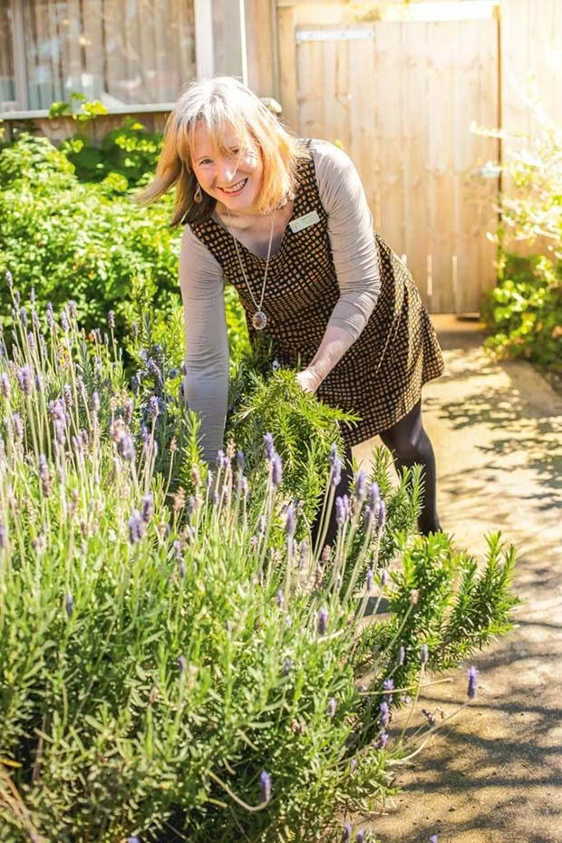 Bronwyn picking rosemary in the herb garden