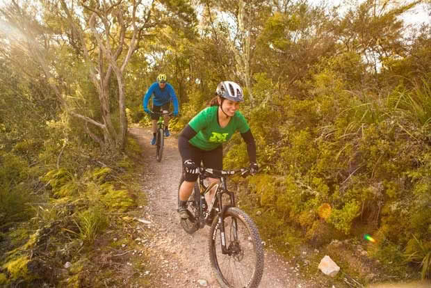 Nadia Coombe and Glenn Cullen explore the Te Ara Ahi – Thermal by Bike trail near Rainbow Mountain during a Rotorua mountain biking trip, Rotorua, New Zealand. 