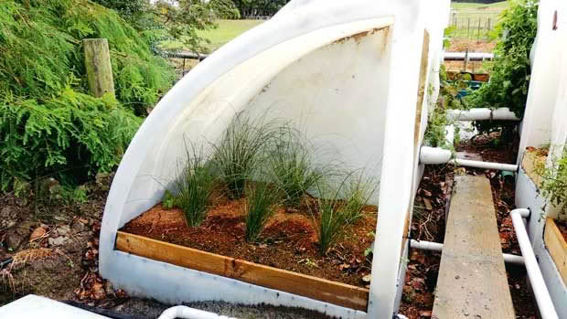 A close-up of one of the quarter-tanks being used as a tunnel house.