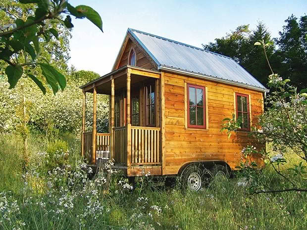 This tiny house includes a porch, bathroom, kitchen and an upstairs loft for sleeping in a space measuring 2.4m wide by 4.6m.