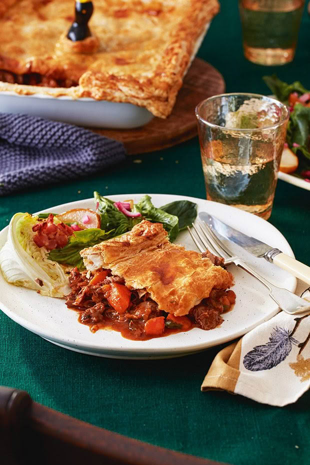 A plate with a braised lamb shank and sweet potato (kumara) pie. 