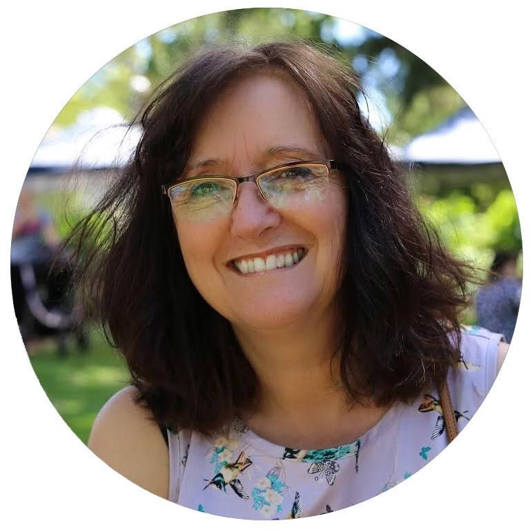 A woman wearing glasses is smiling in a circle