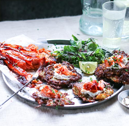 A plate of food with a glass of water in the background