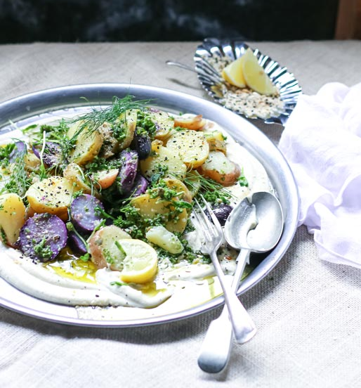A plate of food with a fork and spoon on a table